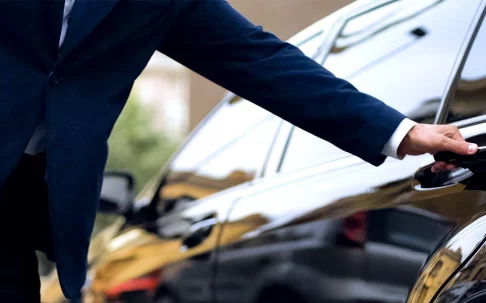 driver opening black car door